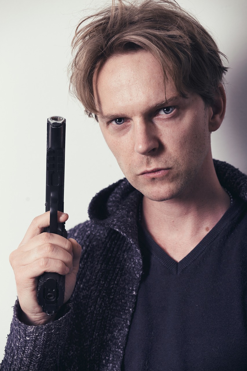 a man has a gun in the hand