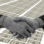 Hands shaking on a background of US dollars