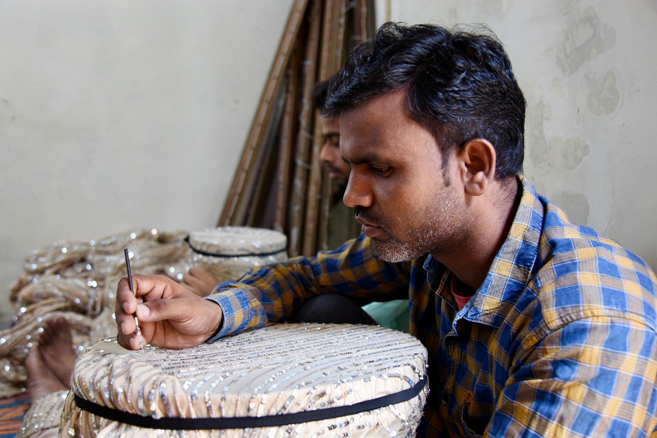 man doing embroidery