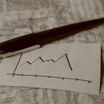 a paper and a pen on a table with a grid drawn