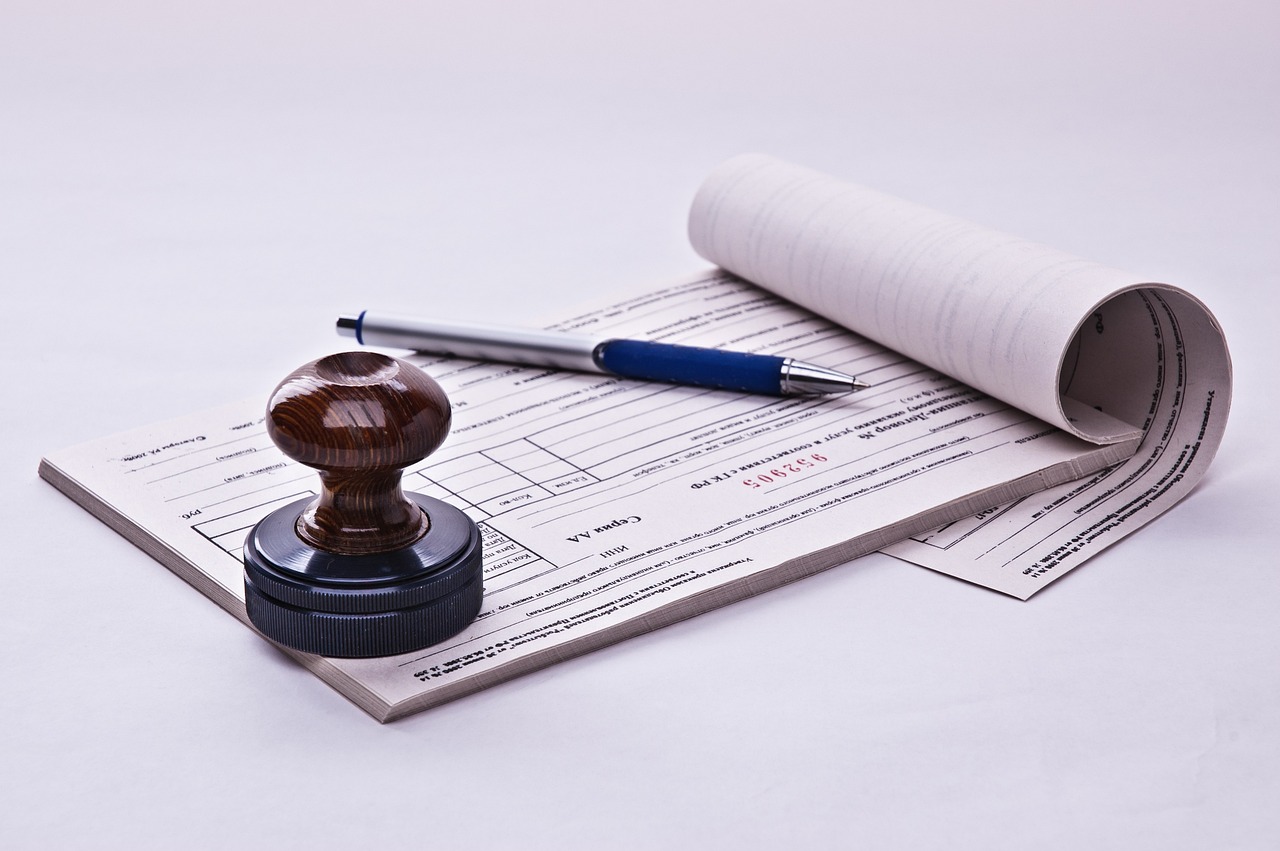 stamp paper with  a pen and a stamp on it