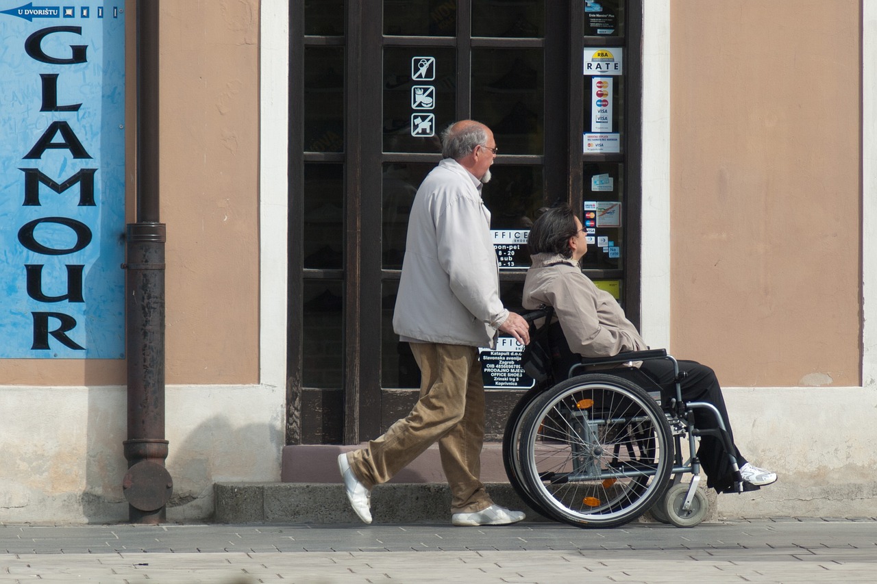 lady sitting on wheelchair and man is pulling it